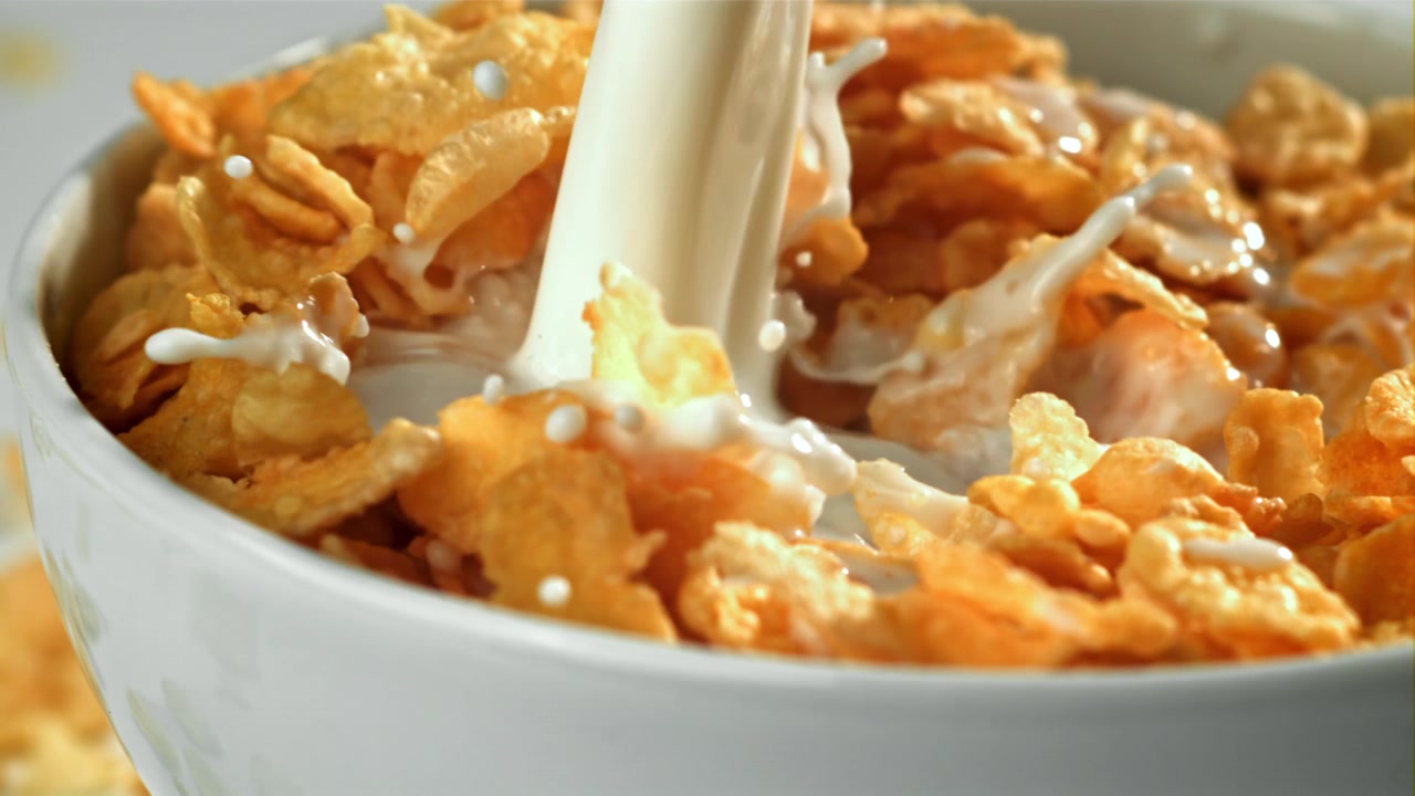 Slow Motion Milk Pouring into a Bowl of Crispy Cornflakes