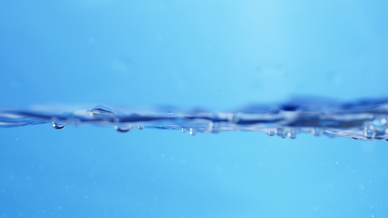 Refreshing Aqua Clean Water Droplets Cascading in Slow Motion