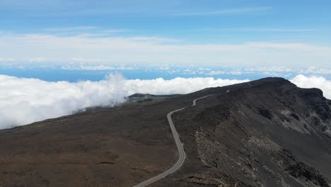 high altitude road by crater on haleakala volcano summit on maui island in hawaii, aerial