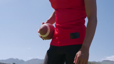 american football player holding a ball