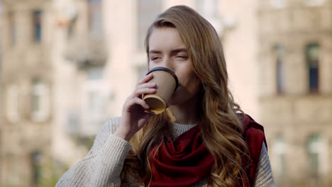 Pretty-woman-drinking-coffee-outdoors.-Hipster-girl-enjoying-hot-drink-on-city