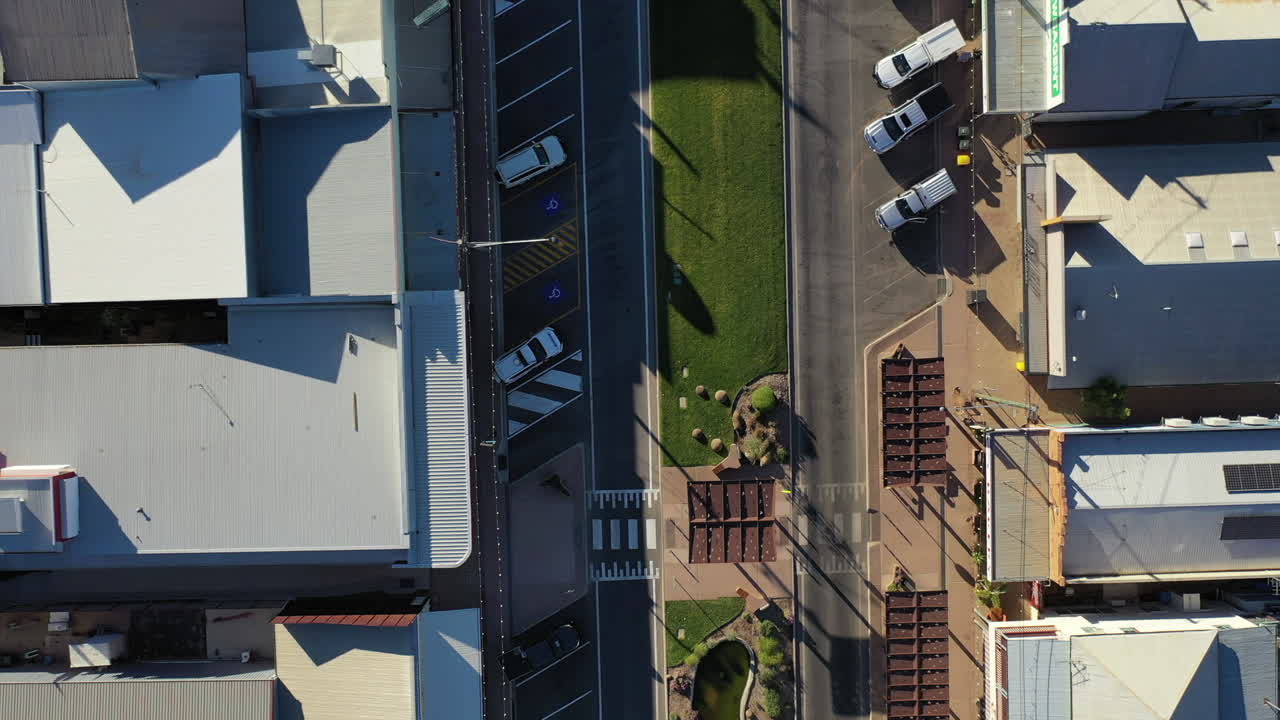 Aerial: Top down birds eye view drone shot moving down the main high street, in Winton QLD Australia