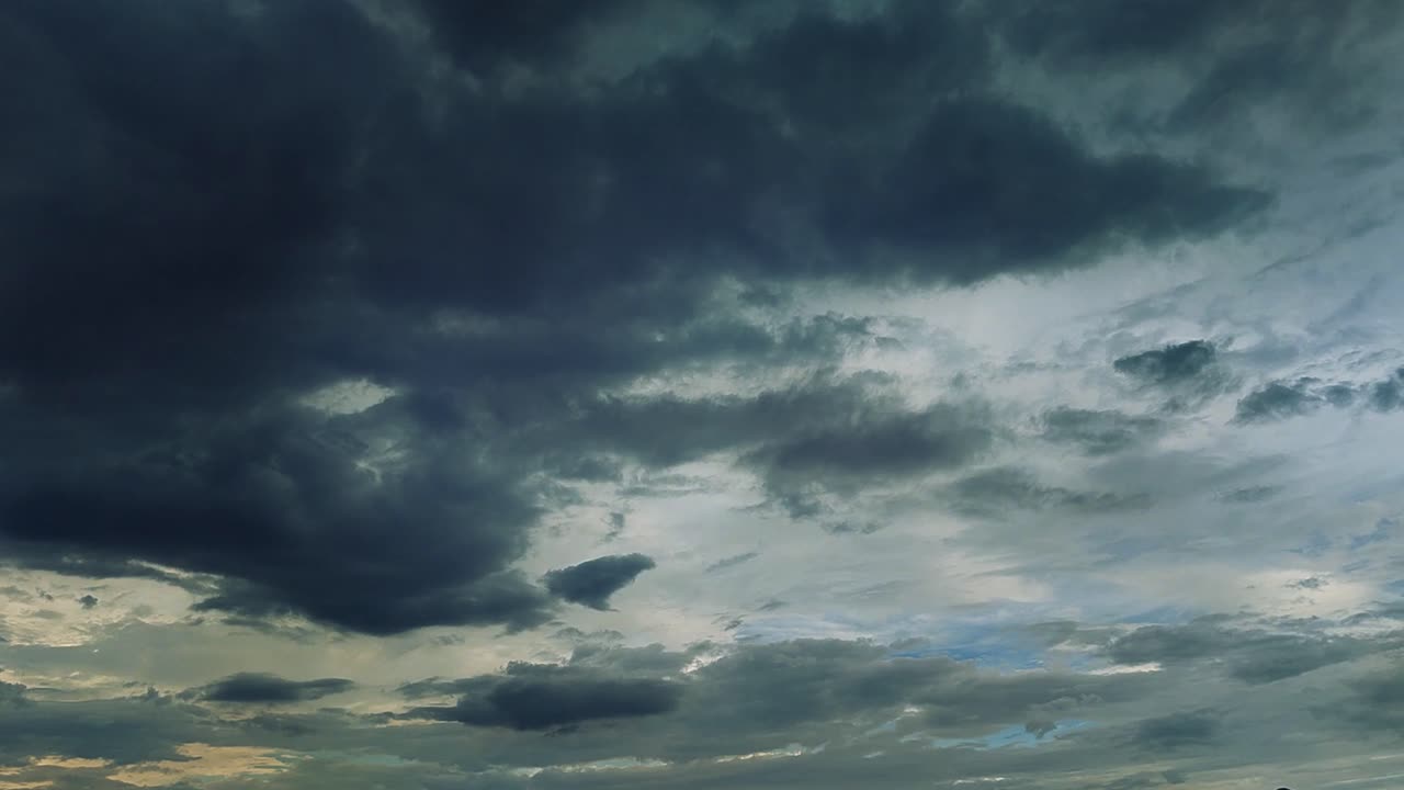 Timelapse of dramatic clouds moving across sky with textured formations and light breaking through. Great for cinematic backgrounds and weather transitions.