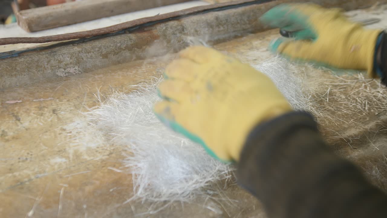 Placing CSM fiberglass over boat hull damage dry fitting