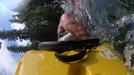 rolling a kayak in a river, close up and in slow motion.