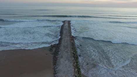 Sea-wall-shott-at-sunset-with-a-family-wlaking