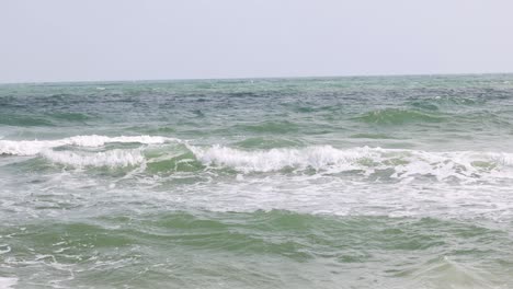 sequential view of ocean waves hitting the beach