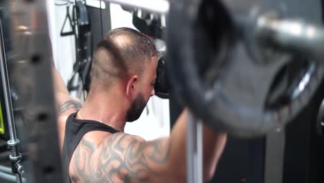 A-muscular-male-bodybuilder-lifting-weights-at-the-gym