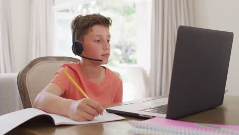 happy caucasian boy having video call on laptop