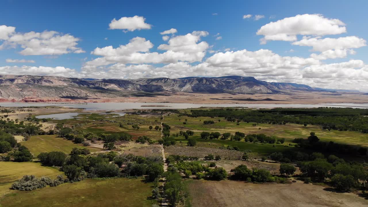 Scenic Landscape with Mountains, Lake, and Clouds