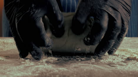 Kneading Dough with Black Gloves