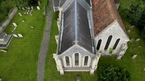 an upward tilt shot of holy cross church in goodnestone, tilting up from the east window to the tower