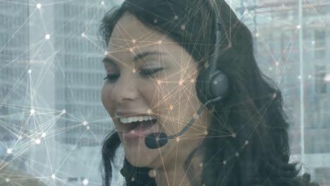 Animation-of-networks-of-connections-over-businesswoman-wearing-phone-headset