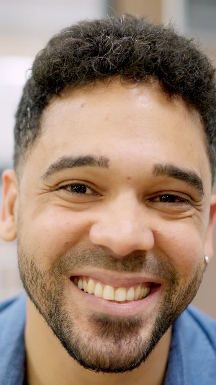 Hispanic man smiling at camera working in a coworking