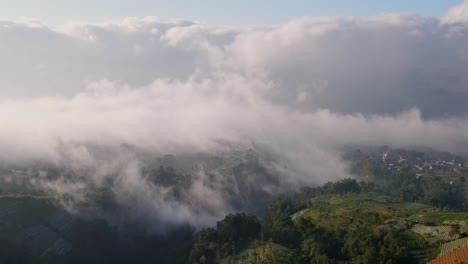 Majestic-panorama-of-high-altitude-countryside,-mist-moving-across-the-sky,-aerial-orbit