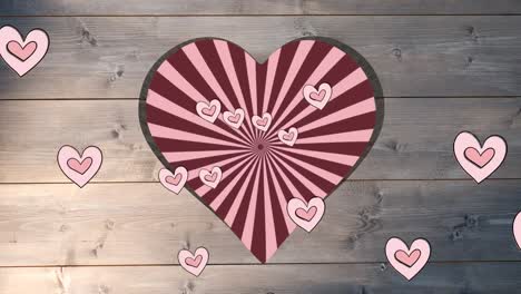 animation of rotating red striped background over heart shapes hole in beige wooden surface