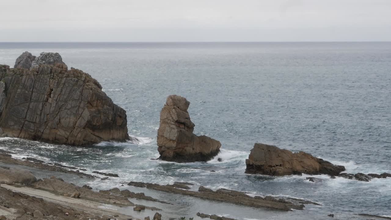 Rock formations by the sea at Arnia Beach in Soto de la Marina, Cantabria, Spain