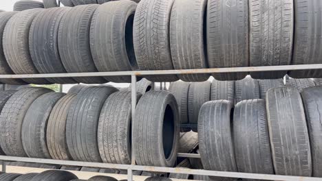 a large collection of used car tires stacked on metal shelves
