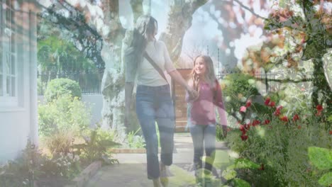 composite video of tall tress against caucasian mother and daughter holding hands walking together