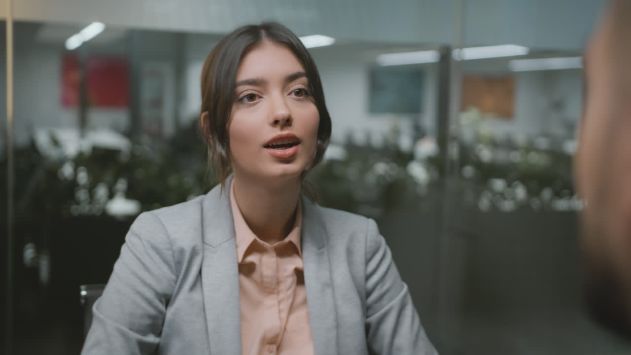 A young businesswoman having a conversation in an office meeting