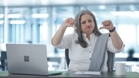 Happy-Indian-senior-businesswoman-showing-thumbs-down