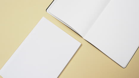 video of books with white blank pages and copy space on yellow background