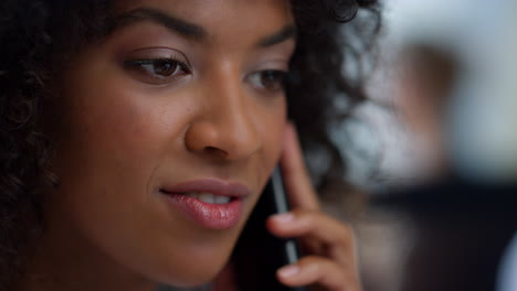 Smiling-female-manager-calling-on-mobile-phone