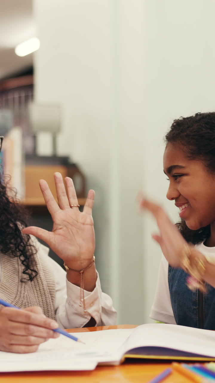 Happy Teacher and Student High-Fiving After a Successful Learning Session