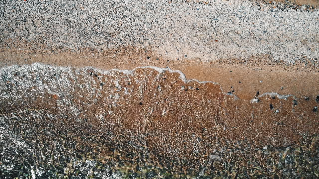 Waves of the sea on a beach. Top view