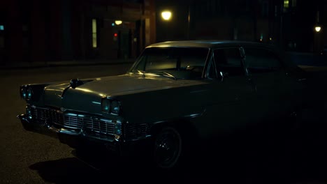 vintage car on a city street at night