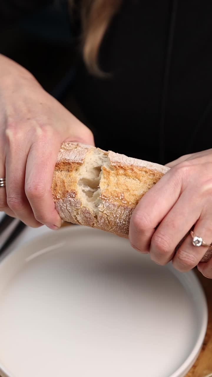 Breaking a loaf of sourdough bread