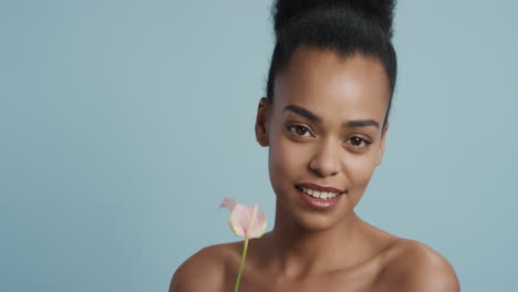 portrait beautiful young woman holding lily flower smiling enjoying healthy skincare happy female with perfect natural beauty on blue background