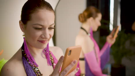 a showgirl looking at something at ther mobile phone