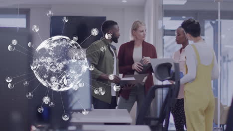 animation of globe with icons over diverse business people in office