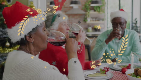 animation of christmas pattern over senior diverse friends in santa hats at christmas meal table