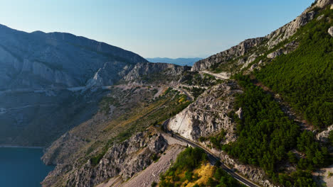 AERIAL:-Mountainous-winding-road-on-the-Makarska-riviera,-sunny-day-in-Croatia