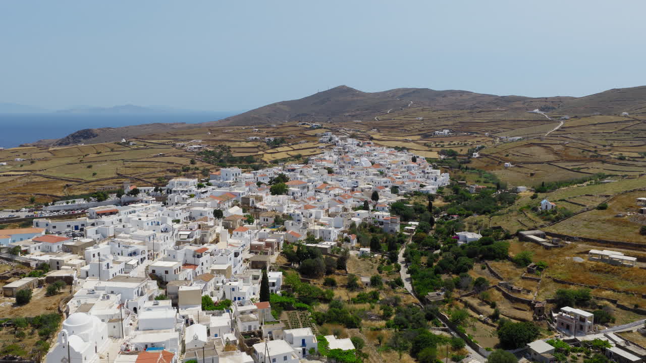 Kythnos Chora seaside settlement on Kythnos island on hilly terrain in the afternoon, Cyclades, Drone shot, Closeup