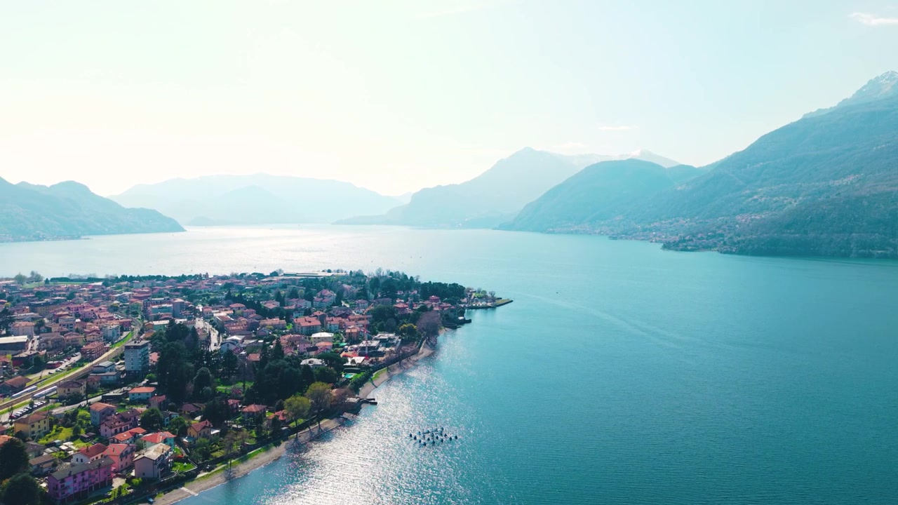 Sorvolo con drone di un villaggio del Lago di Como e acqua cristallina.