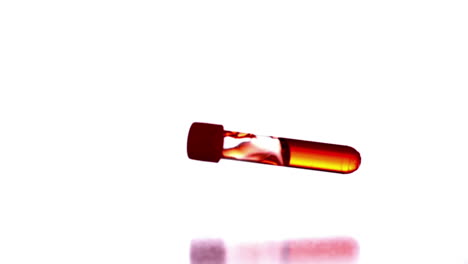 test tube with red liquid falling