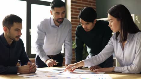 a diverse group of professionals collaborating over business analytics during a meeting in a modern workspace, engaged in discussion and strategy development