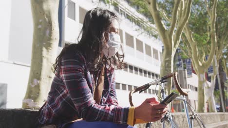 Mixed-race-woman-wearing-medical-coronavirus-mask-on-the-street