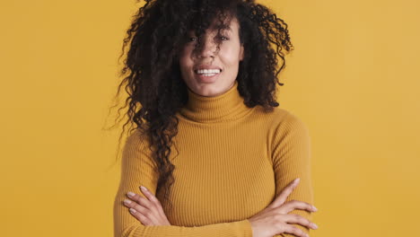 african american smiling woman over orange background.