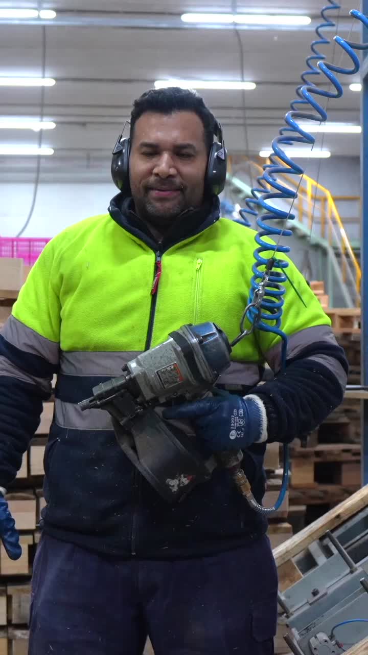 Man using nail gun in a factory