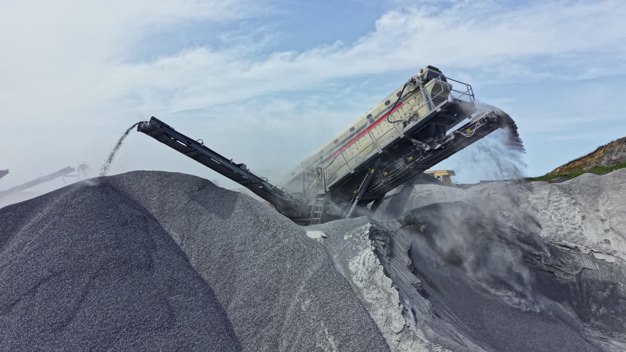 Granite quarry operation showing machinery processing stone at a site in the afternoon light
