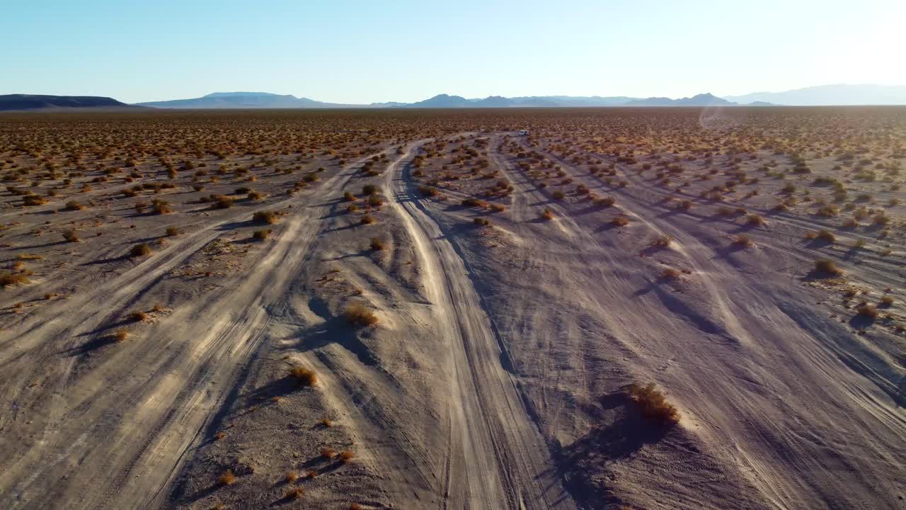 US, NV, Amargossa Valley, Big Dune, 2025-01-16 - Drone view of off road tracks in the desert at sunrise at Big Dune, also known as Amargossa Dune