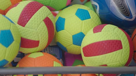 colorful sports balls in a basket