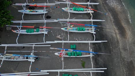 drone revealing shot of hundred of traditional fishing boats on a long beach