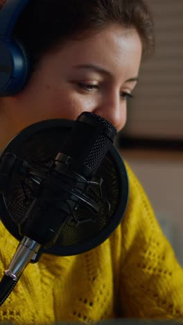 vertical video: happy blogger reading messages of fans using smartphone