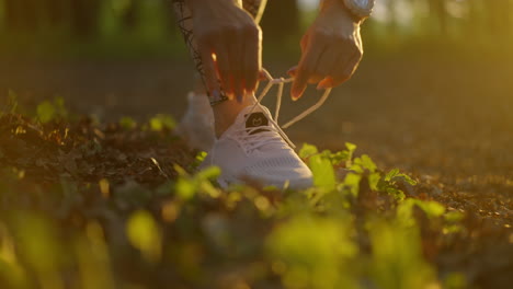 A woman tying her shoelaces before running