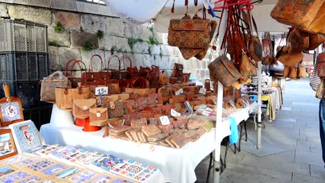 street market in cais da ribeira with handmade bags and tiles, porto